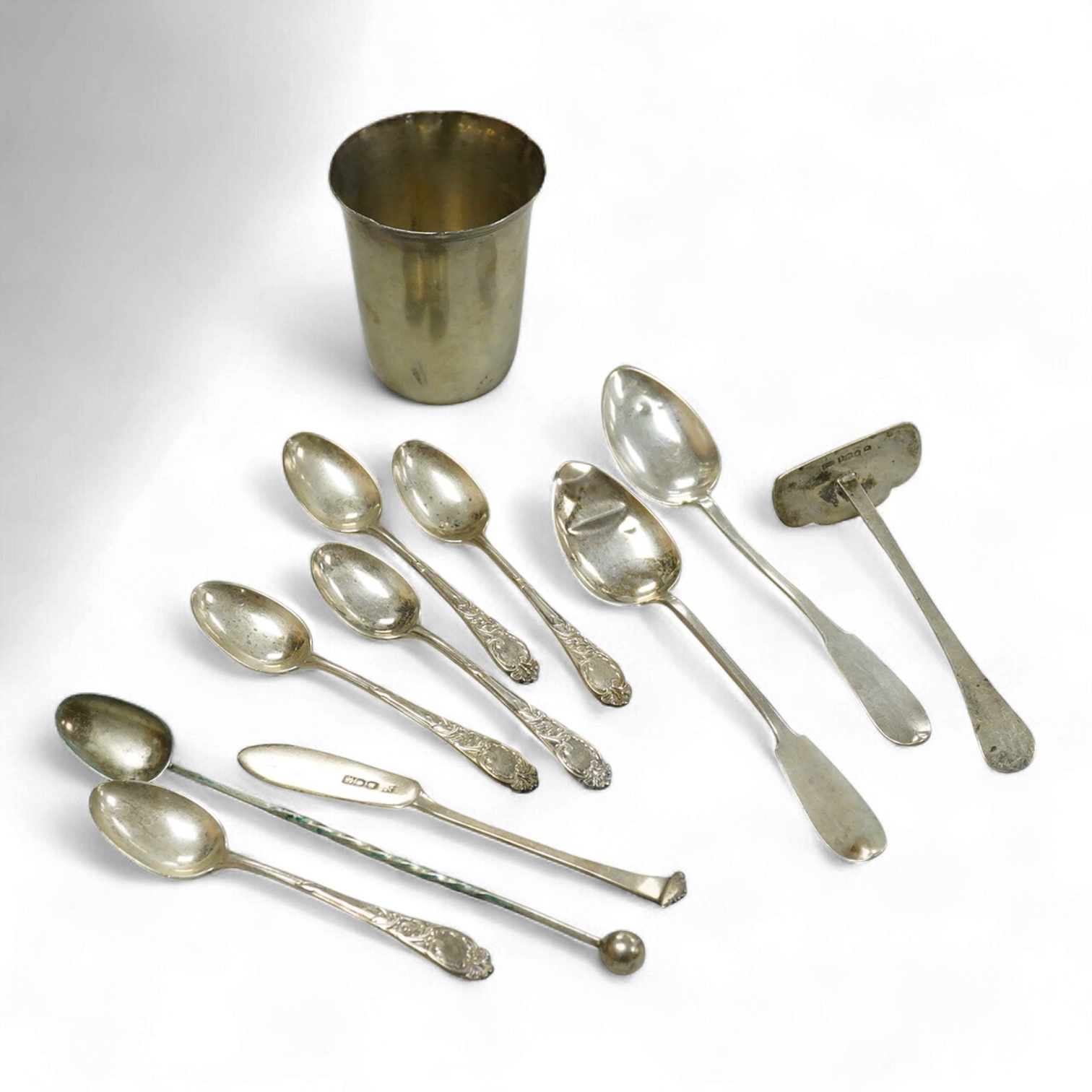 A continental white metal beaker, 69mm, five late Victorian silver coffee spoons, a silver pusher and butter knife and three white metal items.